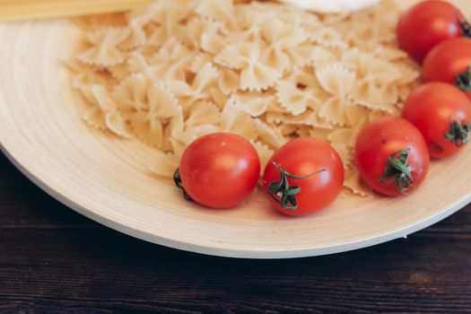 italian pasta pasta cherry tomatoes cooking wooden table. High quality photo