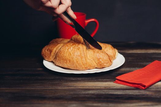 croissants on a white plate red coffee mug. High quality photo