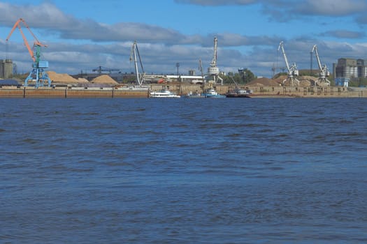 River sand mining. A wide river, a view from the shore.