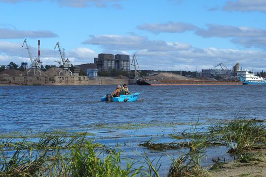 River sand mining. A wide river, a view from the shore.