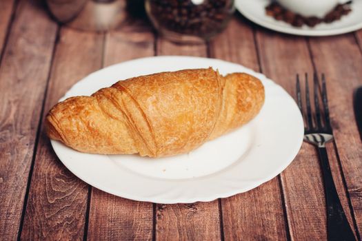 croissant in a plate on the table kitchenware breakfast meal dessert. High quality photo