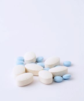 A close up of group of pills on white background.