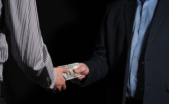 Cash. Transferring money from hand to hand, the man transfers dollars to another man. High quality photo