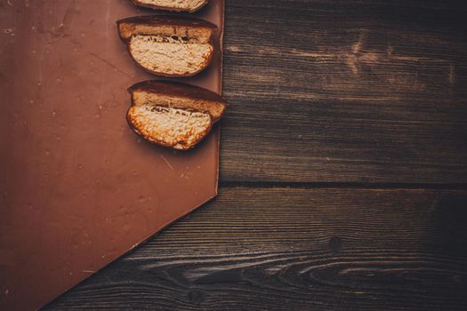 halved brownie and chocolate bar on wooden table. High quality photo