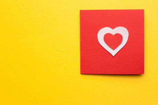 card with heart valentine holiday decoration yellow background. High quality photo