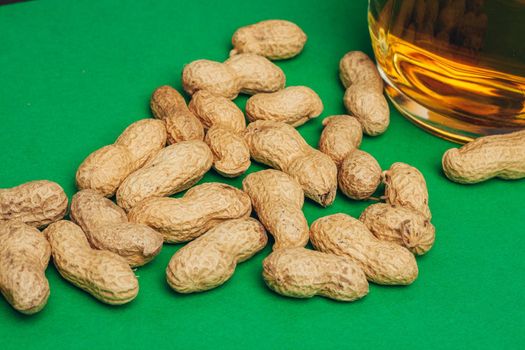 beer peanuts in shells bar alcohol green background. High quality photo