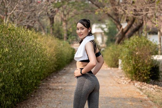 Healthy sports lifestyle. Portrait young asian woman in sports dress doing fitness exercise. Fitness woman streching Relaxing after training.