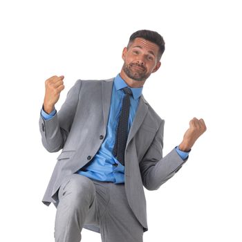 Young business man winner holding fists isolated on white background studio portrait