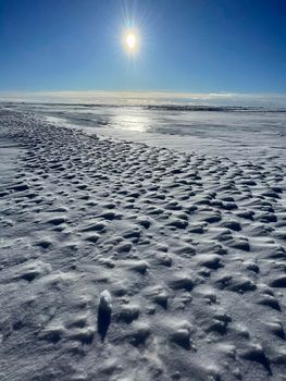 Ice slopes in sunny winter day, transparent ice of blue color, purely blue sky, long shadows, a pure snow-covered virgin soil, snow barkhans, . High quality photo