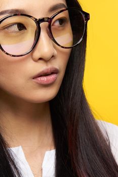 elegant woman of asian appearance with glasses close-up attractive look. High quality photo