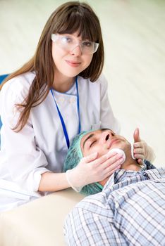Young man visiting female doctor cosmetologyst 