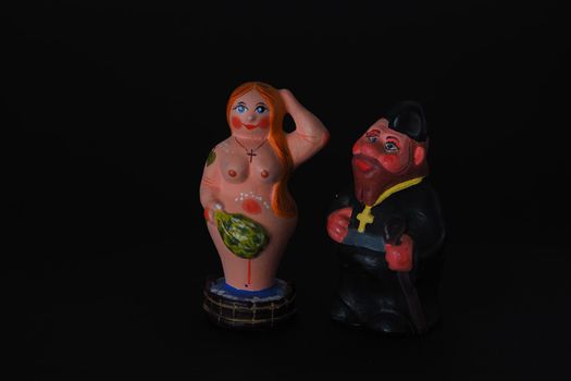 Funny figurines of plaster, clay and ceramics. Bath. The people in the steam room. It's a macro- Black background.