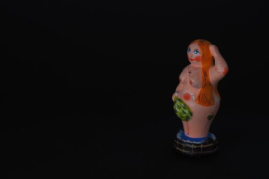 Funny figurines of plaster, clay and ceramics. Bath. The people in the steam room. It's a macro- Black background.