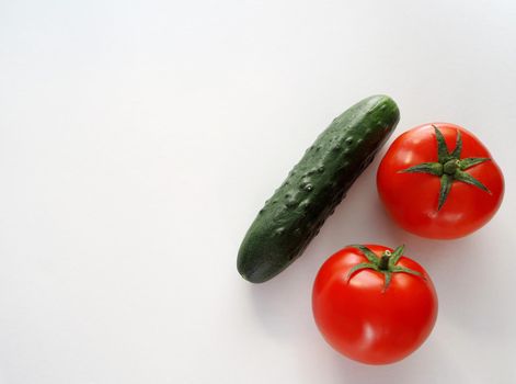 Fresh vegetables. Red tomato, bell pepper, and cucumber. Big plan on a white background.