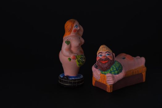 Funny figurines of plaster, clay and ceramics. Bath. The people in the steam room. It's a macro- Black background.