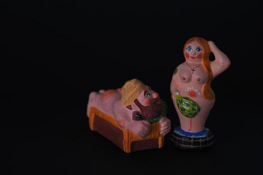 Funny figurines of plaster, clay and ceramics. Bath. The people in the steam room. It's a macro- Black background.