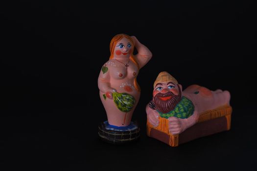 Funny figurines of plaster, clay and ceramics. Bath. The people in the steam room. It's a macro- Black background.