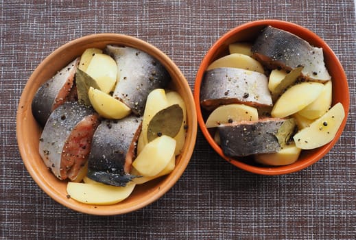 The dish of fish with vegetables is raw. Close-up.