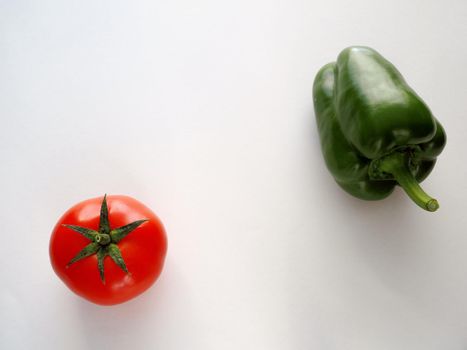 Fresh vegetables. Red tomato and bell pepper sweet. Close-up on a white background.