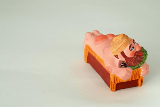 Funny handmade ceramic figurines.The man in the bath.Souvenir and clay.