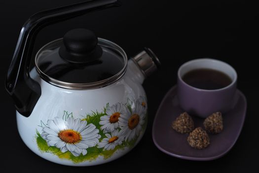 The kettle is enamelled, with a whistle, white. Close-up. 