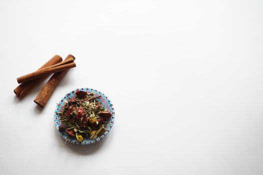  Cinnamon, dried sticks on a white background with fragrant tea