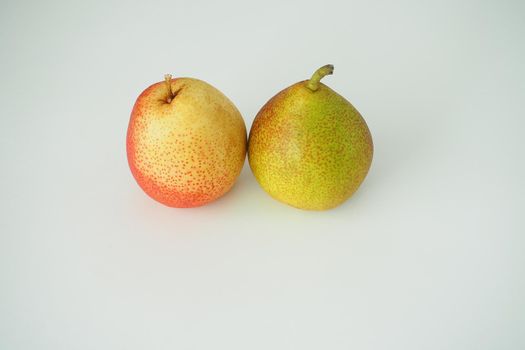 Fruit. Two ripe pears. Close-up. White background