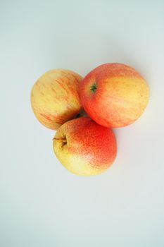 Ripe apples and pear close-up on a white background.