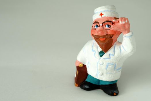 Funny handmade ceramic figurines. Souvenir. Doctor in a white coat.