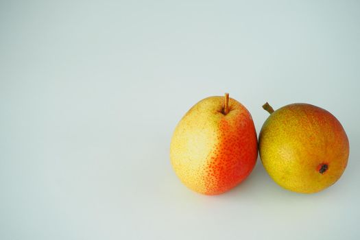 Fruit. Two ripe pears. Close-up. White background