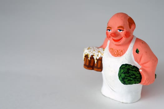 Funny figurines of ceramics, plaster and clay. A man in a bath with a broom. Close-up.