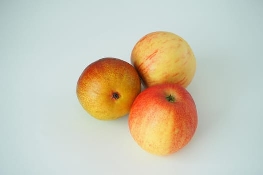 Ripe gouache and apples close-up on a white background. Close-up