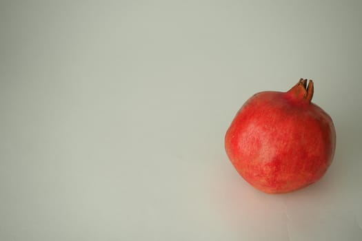 Pomegranate ripe, red round fruit. On a white background
