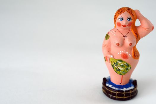 Funny figurines made of clay or plaster ceramics. Souvenir woman in the bath with a broom.
