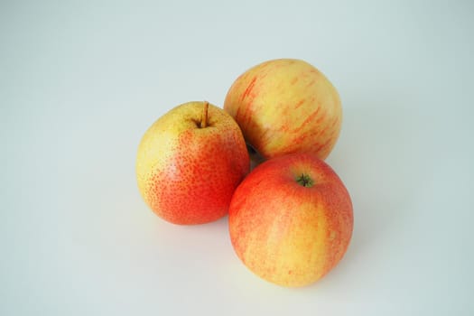 Ripe gouache and apples close-up on a white background. Close-up