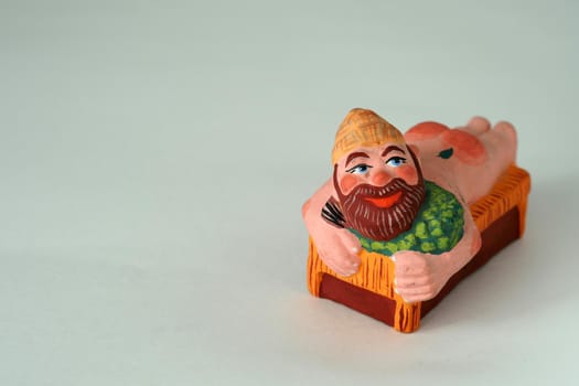 Funny handmade ceramic figurines.The man in the bath.Souvenir and clay.