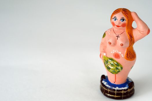 Funny figurines made of clay or plaster ceramics. Souvenir woman in the bath with a broom.