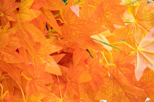 artificial yellow tree leaves close up as background. High quality photo