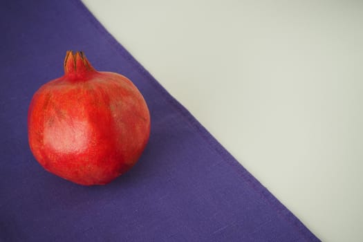 Ripe pomegranate. The red fruit of the fruit. Close-up.