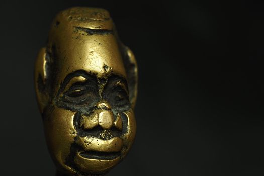 Bronze figurine, sculpture, head on a black background. High quality photo