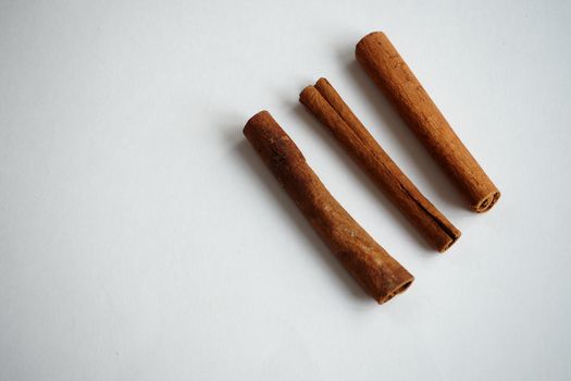  Cinnamon, dried sticks on a white background with fragrant tea