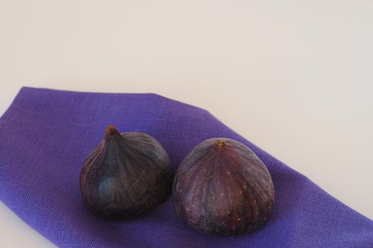 Exotic fruit. Purple figs whole, close-up on a white background.