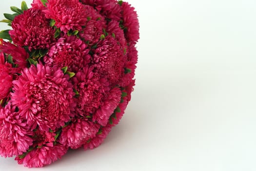 Bouquet of flowers. Asters are pink. Close-up, on a white background.