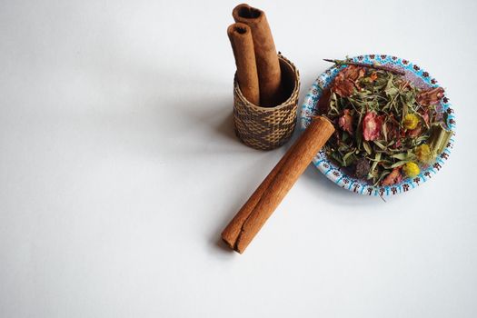  Cinnamon, dried sticks on a white background with fragrant tea