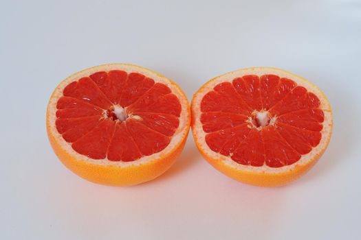 Fruits are citrus fruits. Red grapefruit cut in half. High quality photo