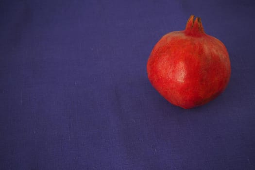 Ripe pomegranate. The red fruit of the fruit. Close-up.