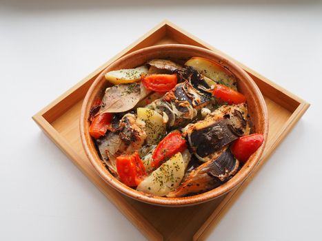 A dish of fish with vegetables baked in the oven. Close-up.