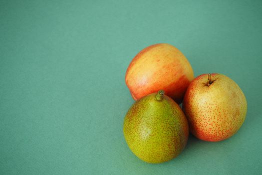 Ripe pears and apples on a ripe background. Close-up.