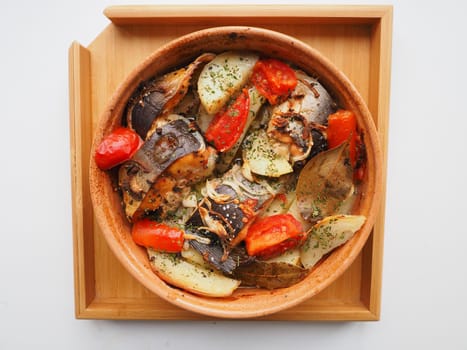 A dish of fish with vegetables baked in the oven. Close-up.