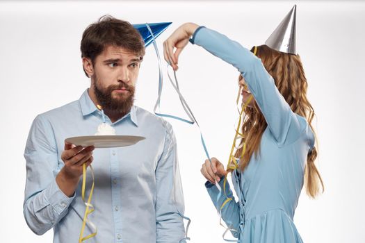 Joyful man and cheerful Woman holiday cake Birthday cap party corporate party young people. High quality photo